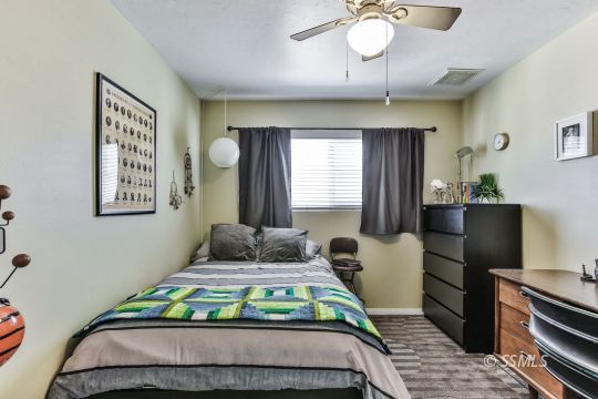 429 West Perdew Avenue Ridgecrest, CA 93555 - Photo 41 of 50 a bedroom with a bed and a chandelier