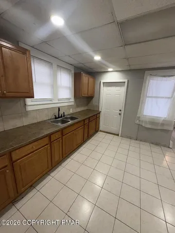 a kitchen with stainless steel appliances a sink dishwasher and a refrigerator