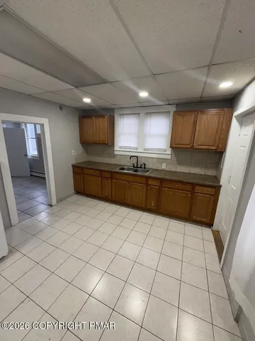 a large kitchen with a stove a sink dishwasher and a refrigerator