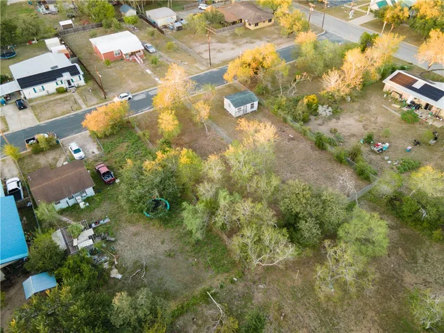 a view of a field with trees in the background