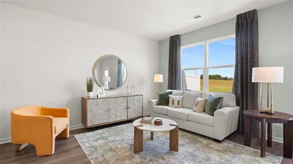 a living room with furniture and a mirror