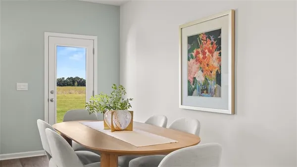 a dining room with furniture and potted plant
