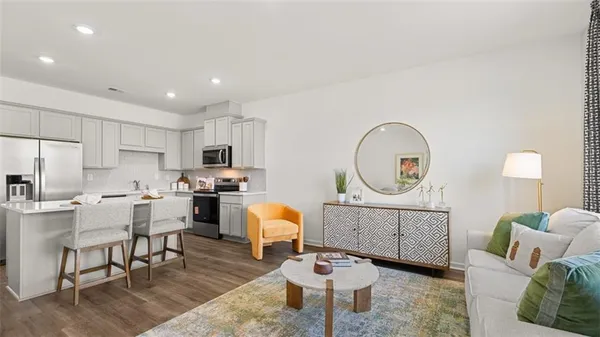 a living room with furniture a mirror and a table