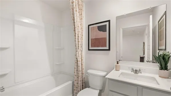 a bathroom with a sink mirror toilet and bathtub