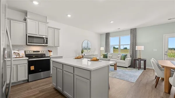 a kitchen with a stove a sink and a refrigerator