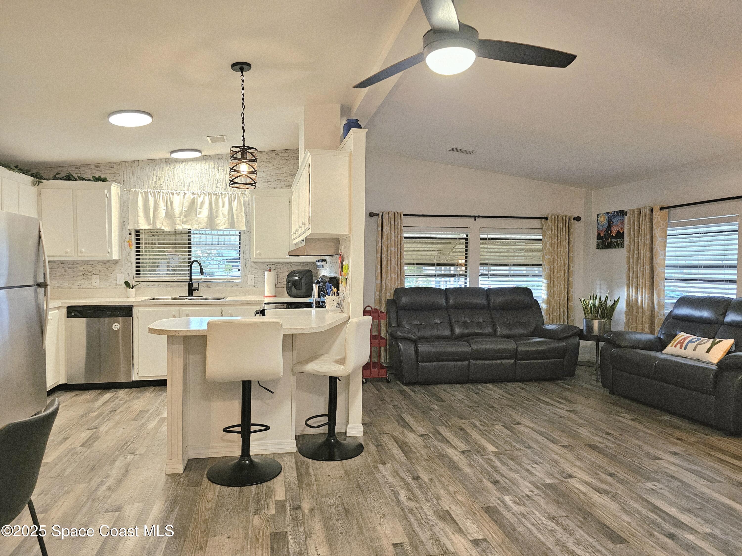 1809 Mango Street Northeast Palm Bay, FL 32905 - Photo 12 of 35 a living room with furniture and a chandelier
