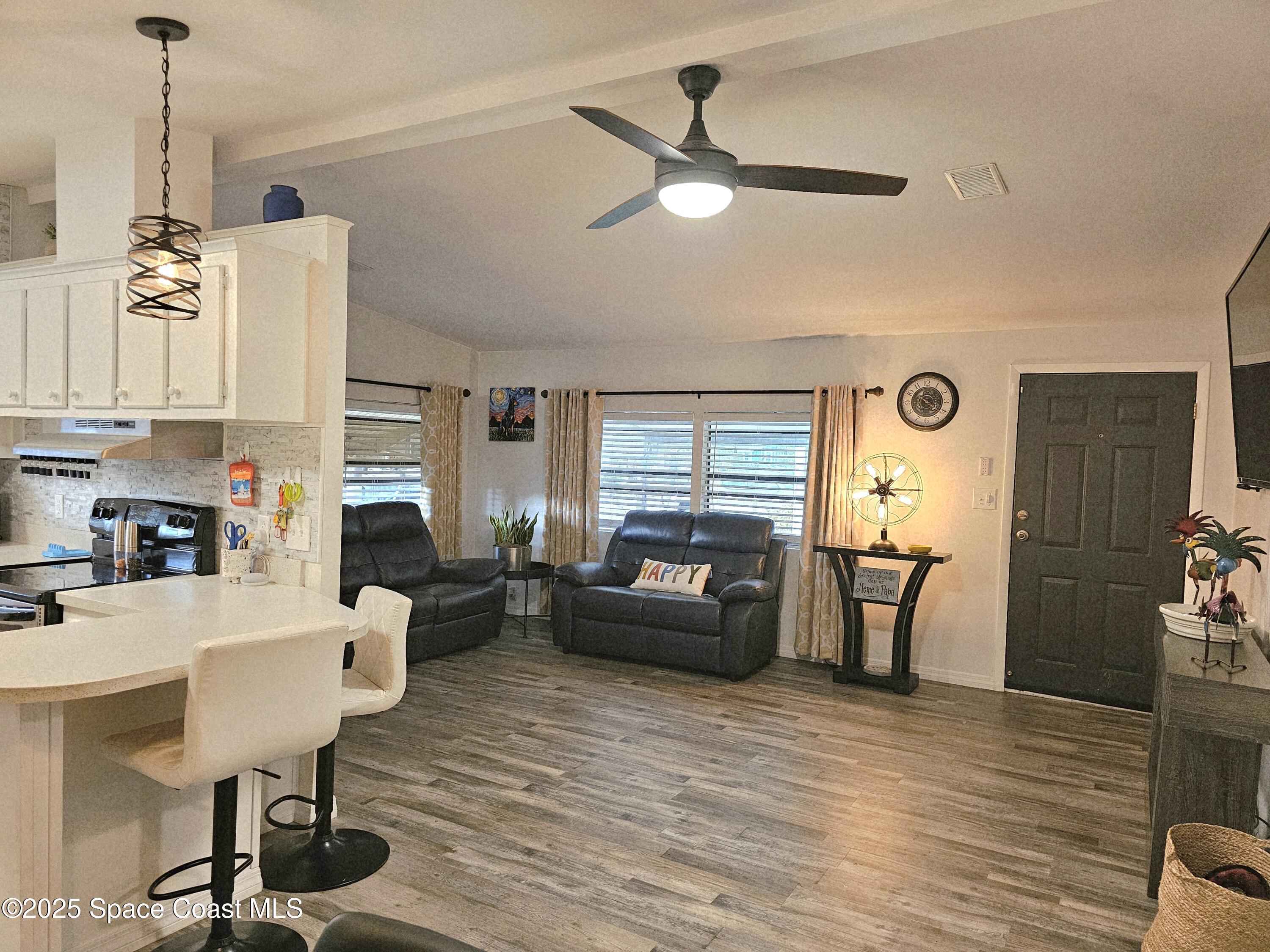 1809 Mango Street Northeast Palm Bay, FL 32905 - Photo 13 of 35 a living room with furniture and a chandelier