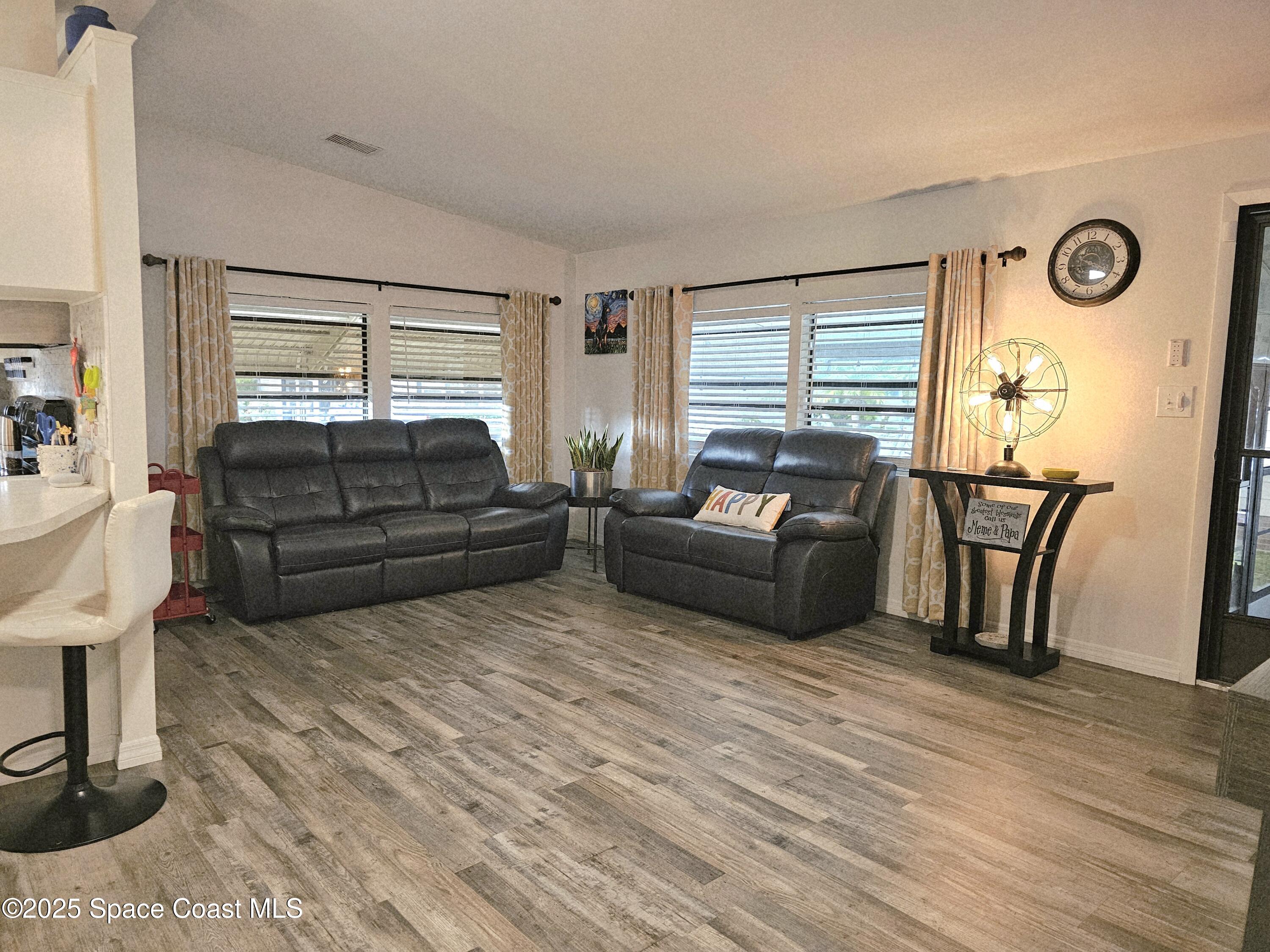 1809 Mango Street Northeast Palm Bay, FL 32905 - Photo 14 of 35 a living room with furniture cabinets and a wooden floor