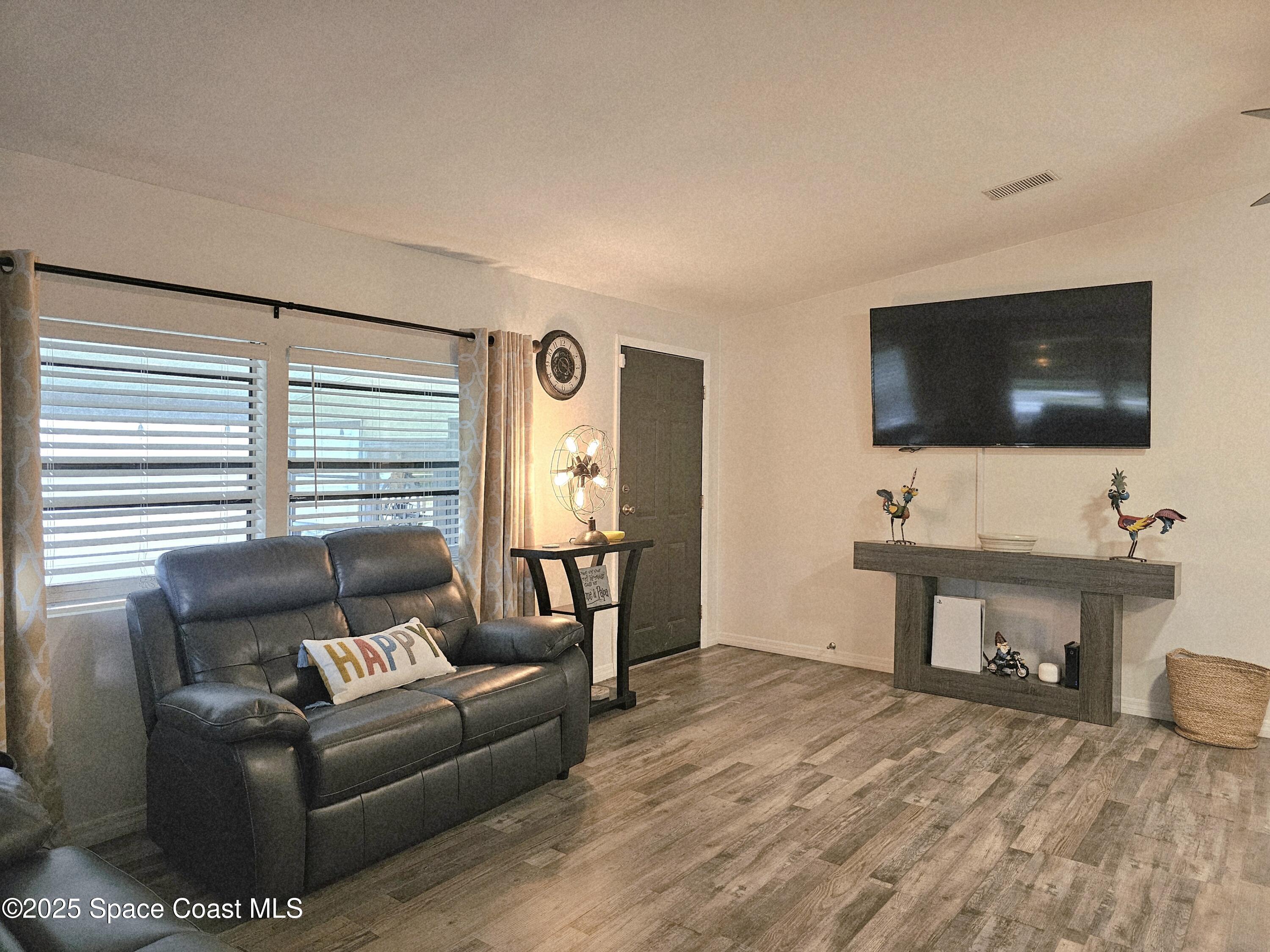 1809 Mango Street Northeast Palm Bay, FL 32905 - Photo 15 of 35 a living room with furniture and a flat screen tv