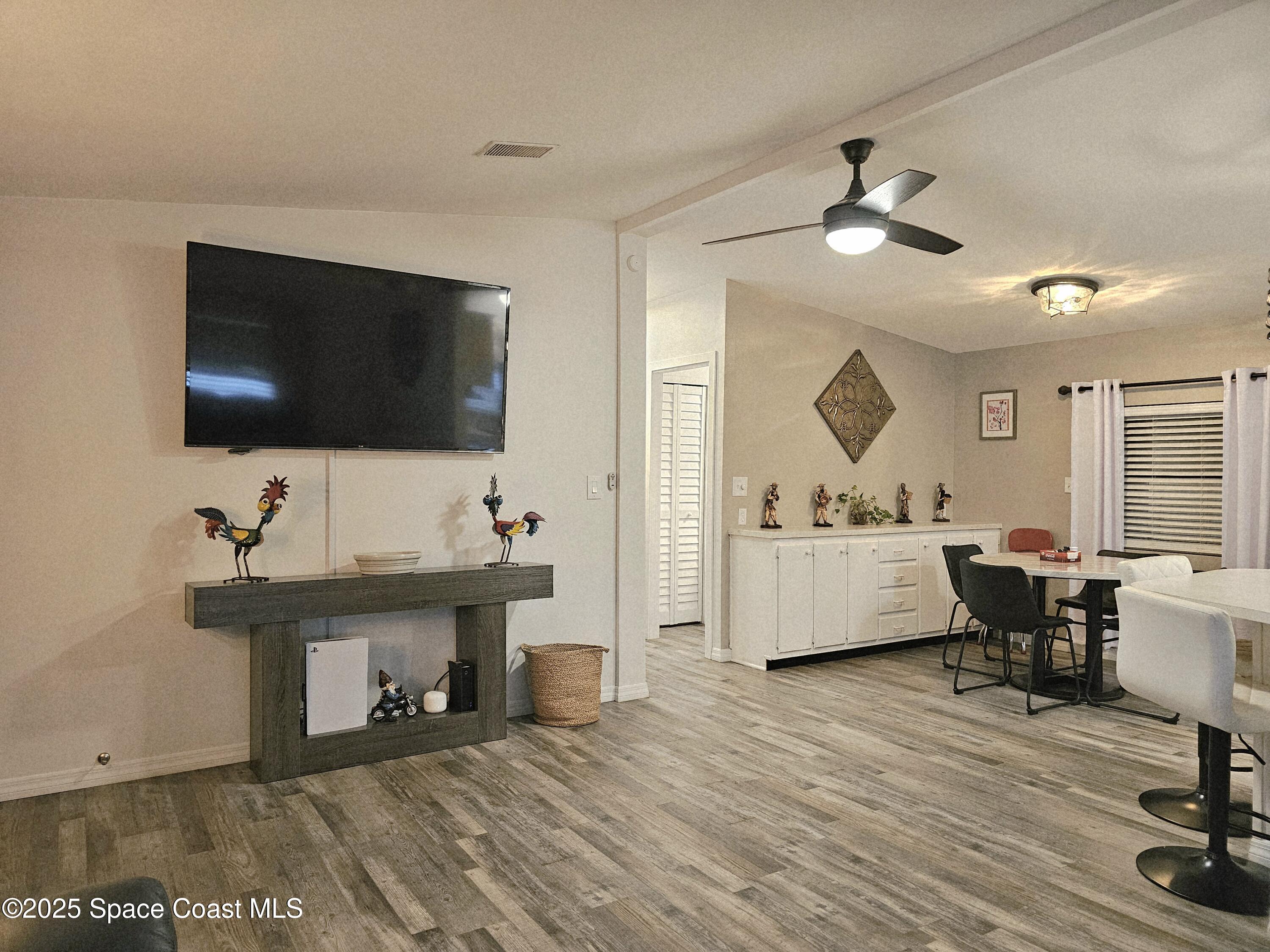 1809 Mango Street Northeast Palm Bay, FL 32905 - Photo 16 of 35 a living room with furniture and a flat screen tv