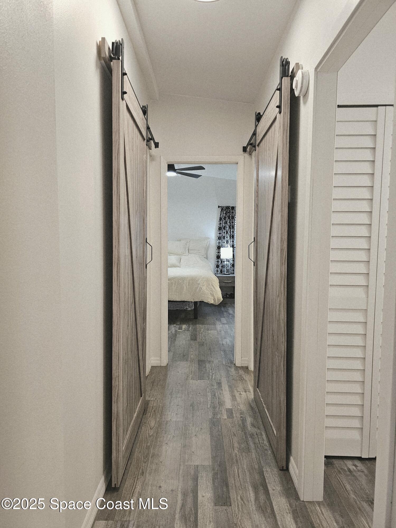 1809 Mango Street Northeast Palm Bay, FL 32905 - Photo 17 of 35 a view of a hallway with wooden floor and staircase