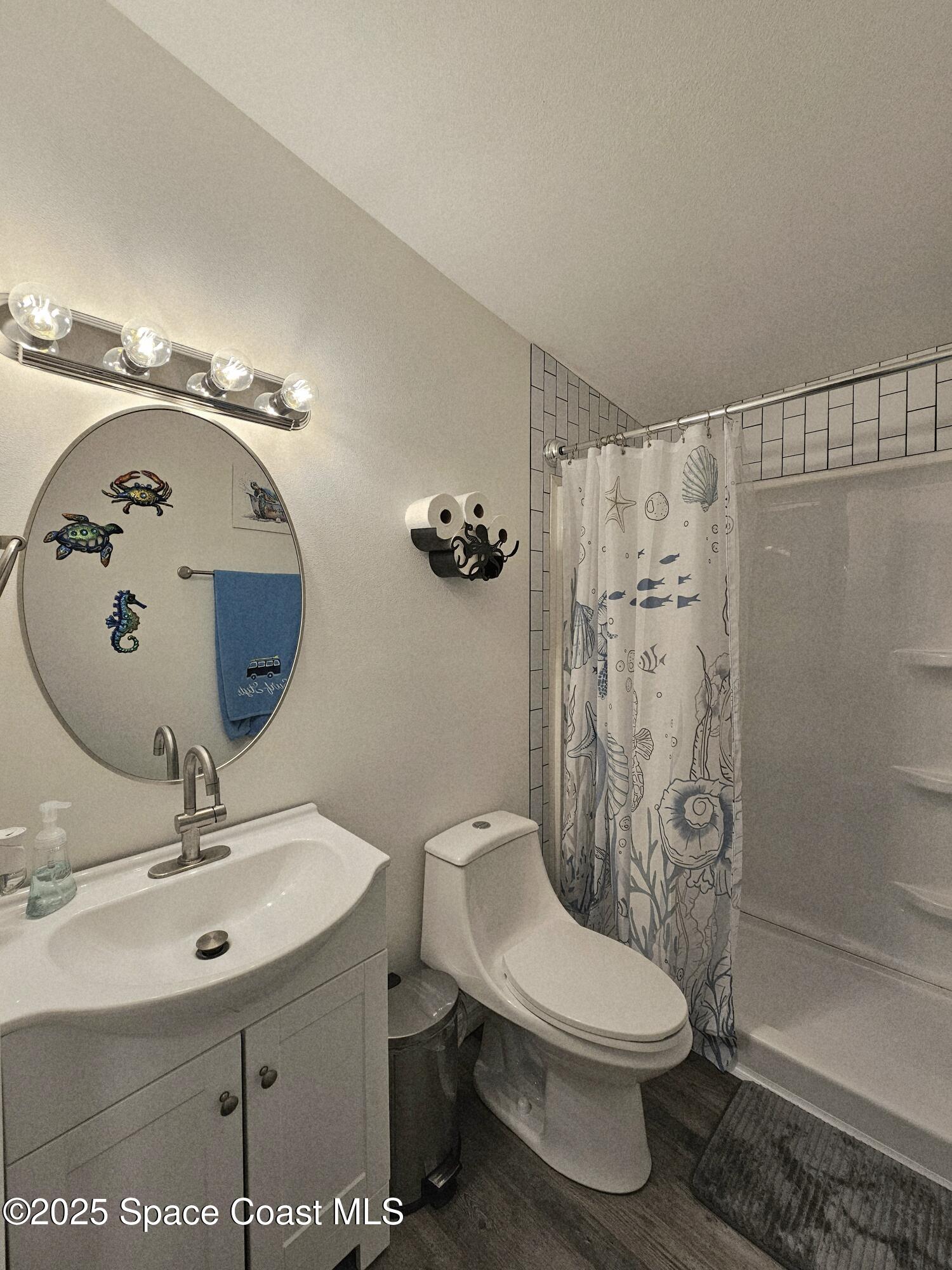 1809 Mango Street Northeast Palm Bay, FL 32905 - Photo 18 of 35 a bathroom with a toilet sink and shower