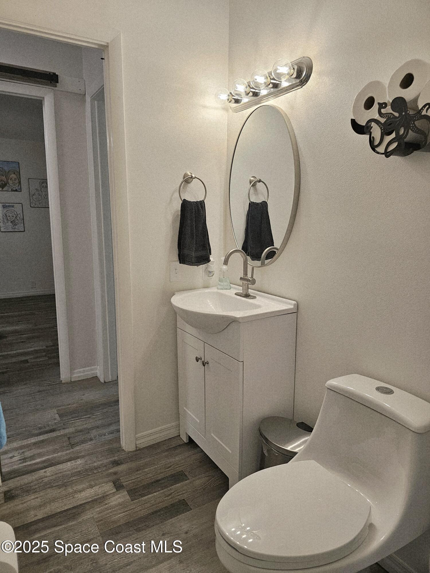 1809 Mango Street Northeast Palm Bay, FL 32905 - Photo 20 of 35 a bathroom with a toilet sink and mirror