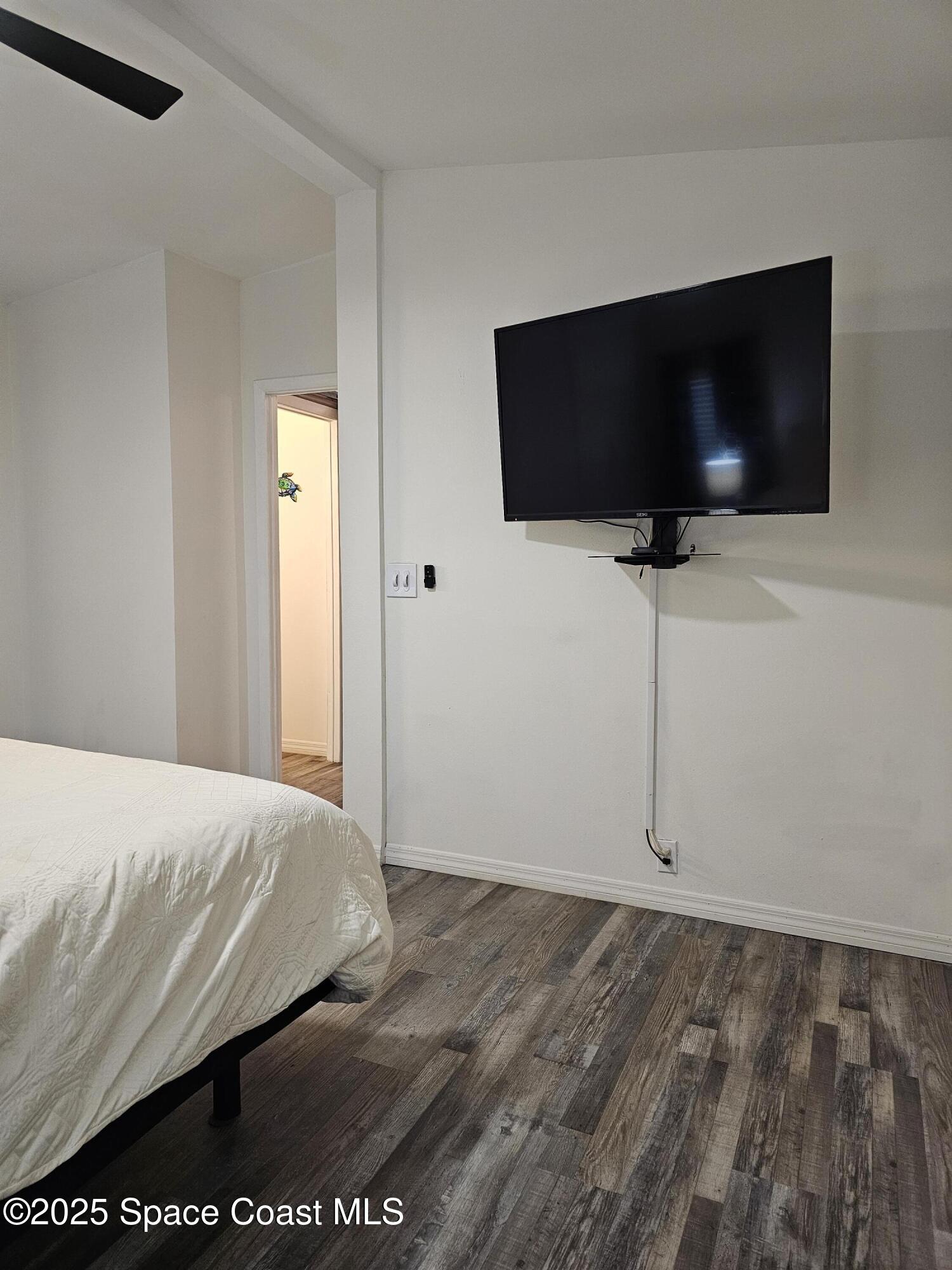 1809 Mango Street Northeast Palm Bay, FL 32905 - Photo 23 of 35 a bedroom with a bed and a flat screen tv