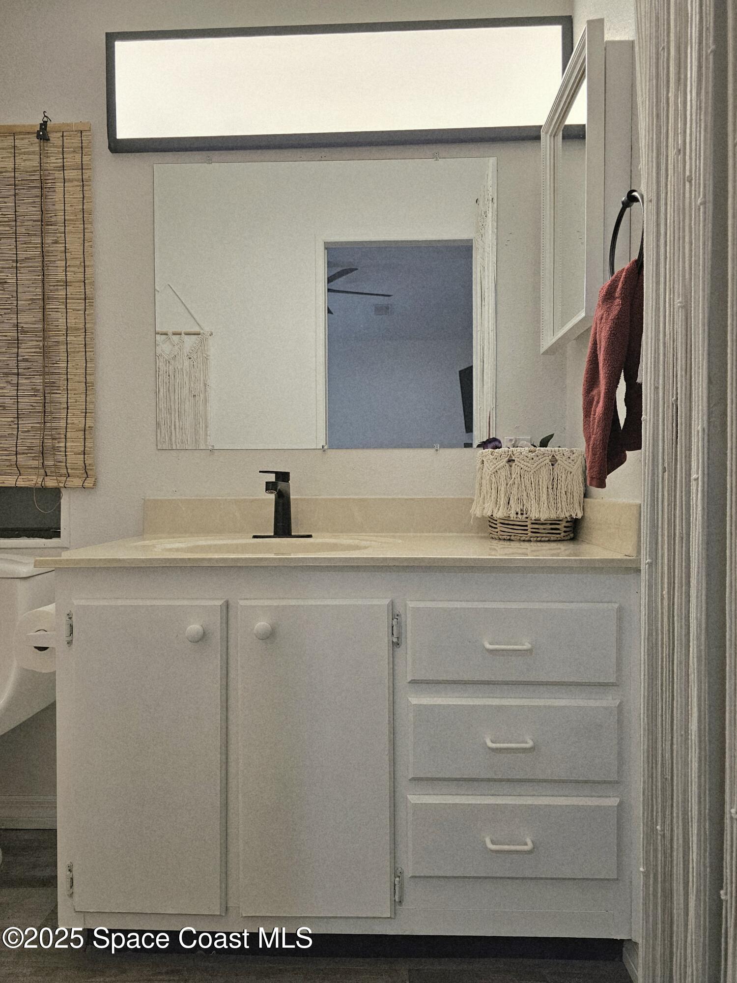 1809 Mango Street Northeast Palm Bay, FL 32905 - Photo 25 of 35 a bathroom with a sink and a mirror