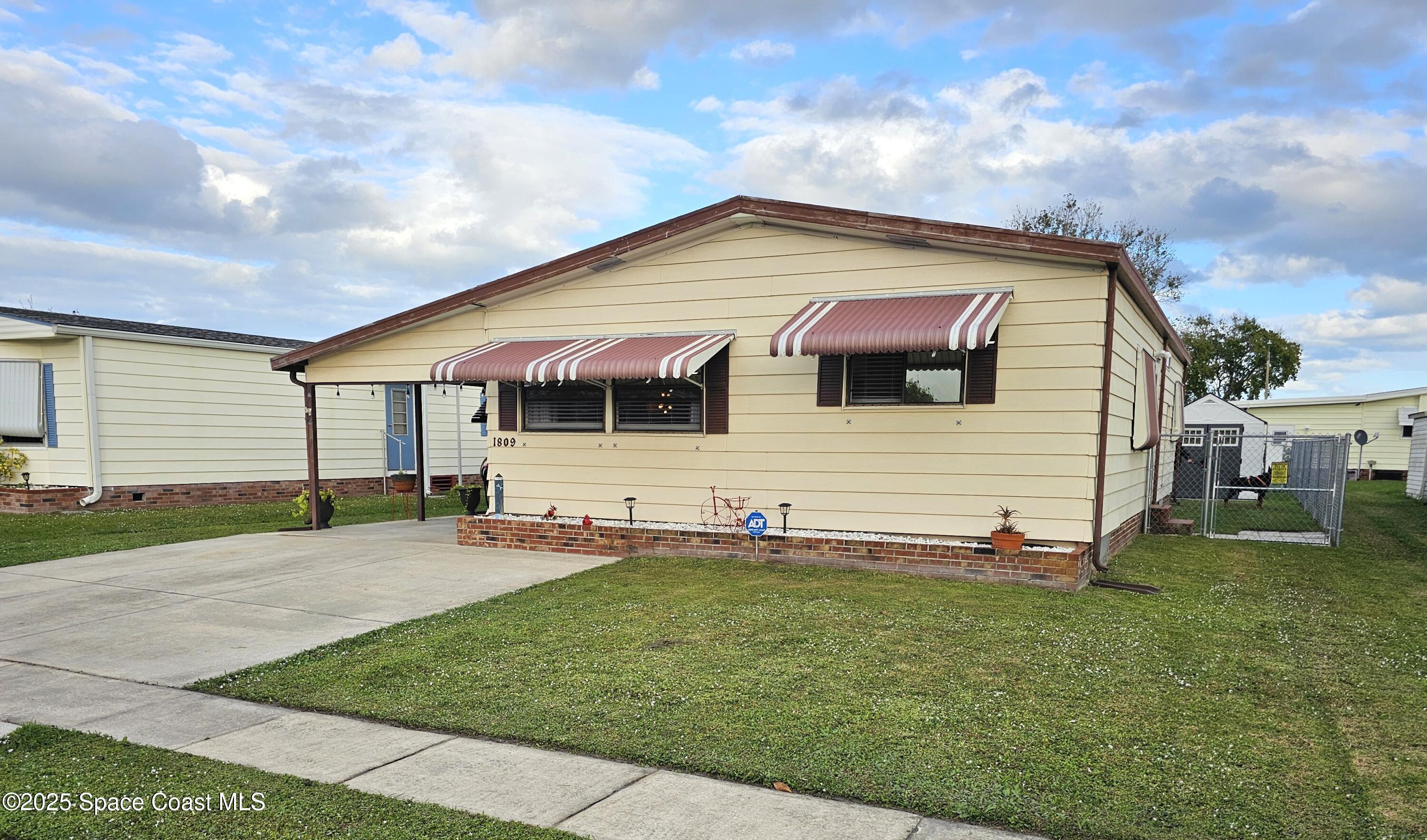1809 Mango Street Northeast Palm Bay, FL 32905 - Photo 3 of 35 a view of house with backyard