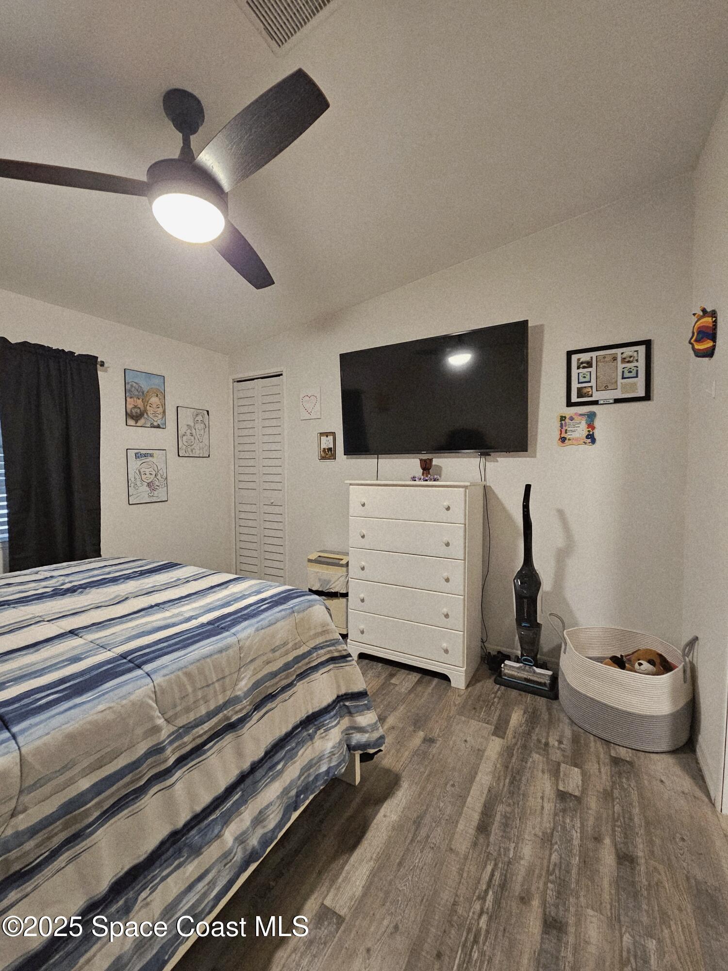 1809 Mango Street Northeast Palm Bay, FL 32905 - Photo 31 of 35 a view of a livingroom with furniture and a flat screen tv