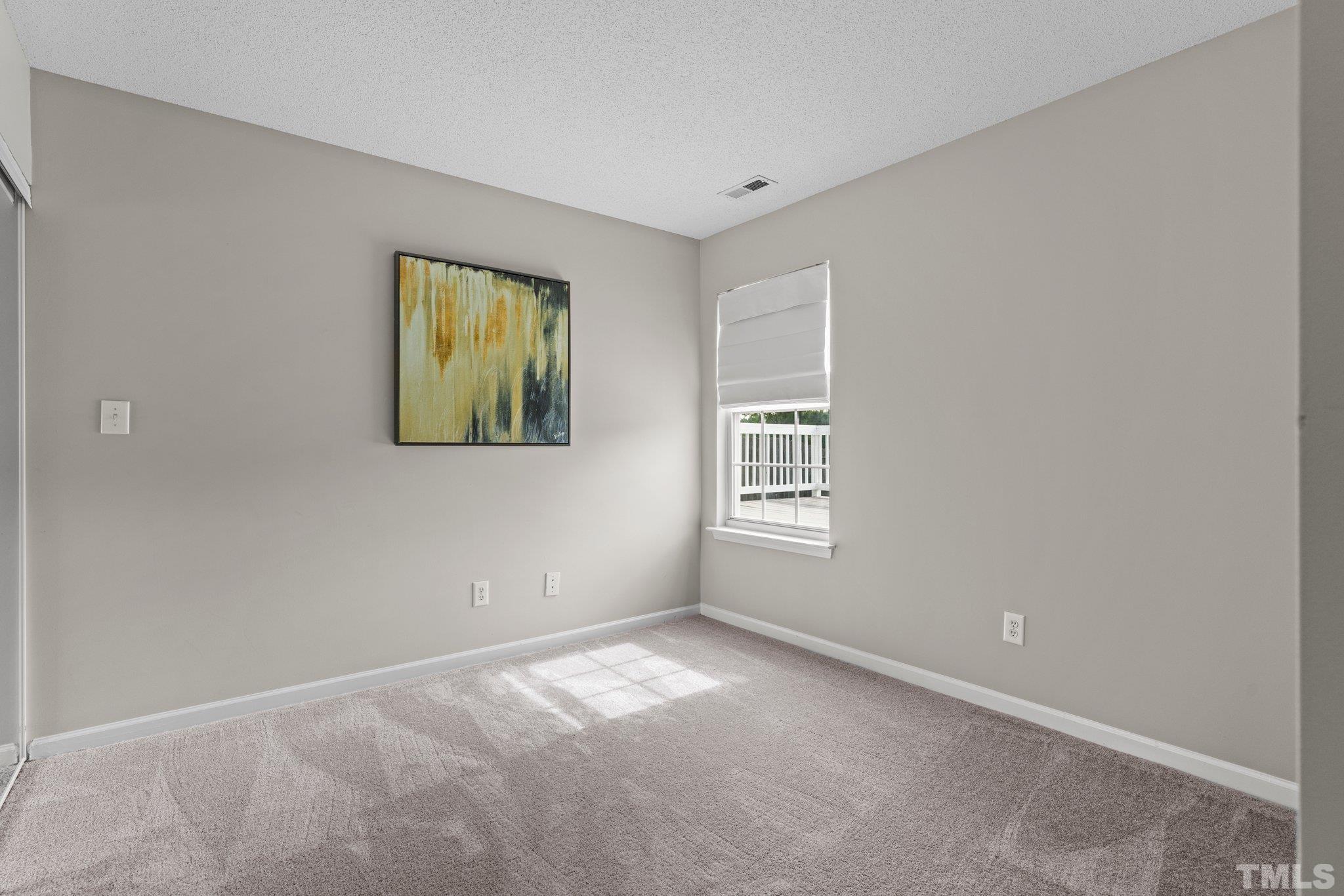 9136 Colony Village Lane Raleigh, NC 27617 - Photo 11 of 17 a view of an empty room with a window