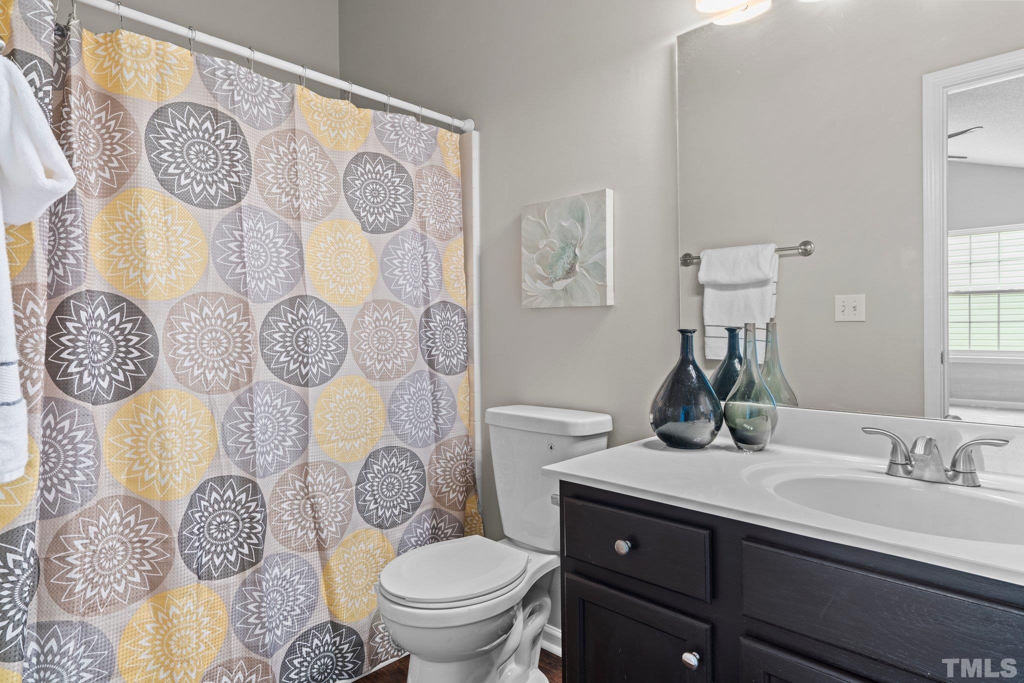 9136 Colony Village Lane Raleigh, NC 27617 - Photo 13 of 17 a bathroom with a toilet sink and mirror