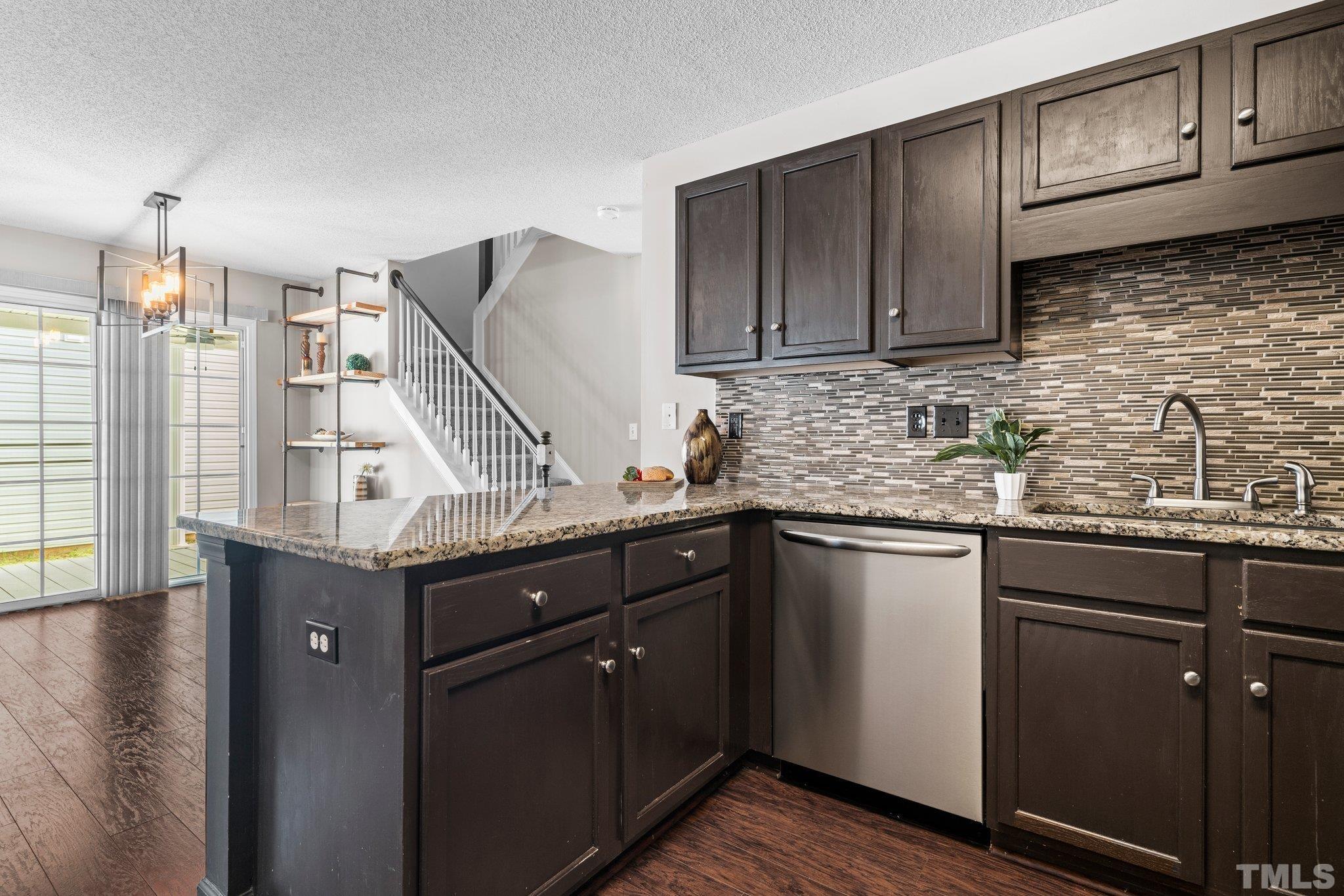 9136 Colony Village Lane Raleigh, NC 27617 - Photo 4 of 17 a kitchen with stainless steel appliances granite countertop a sink stove and cabinets