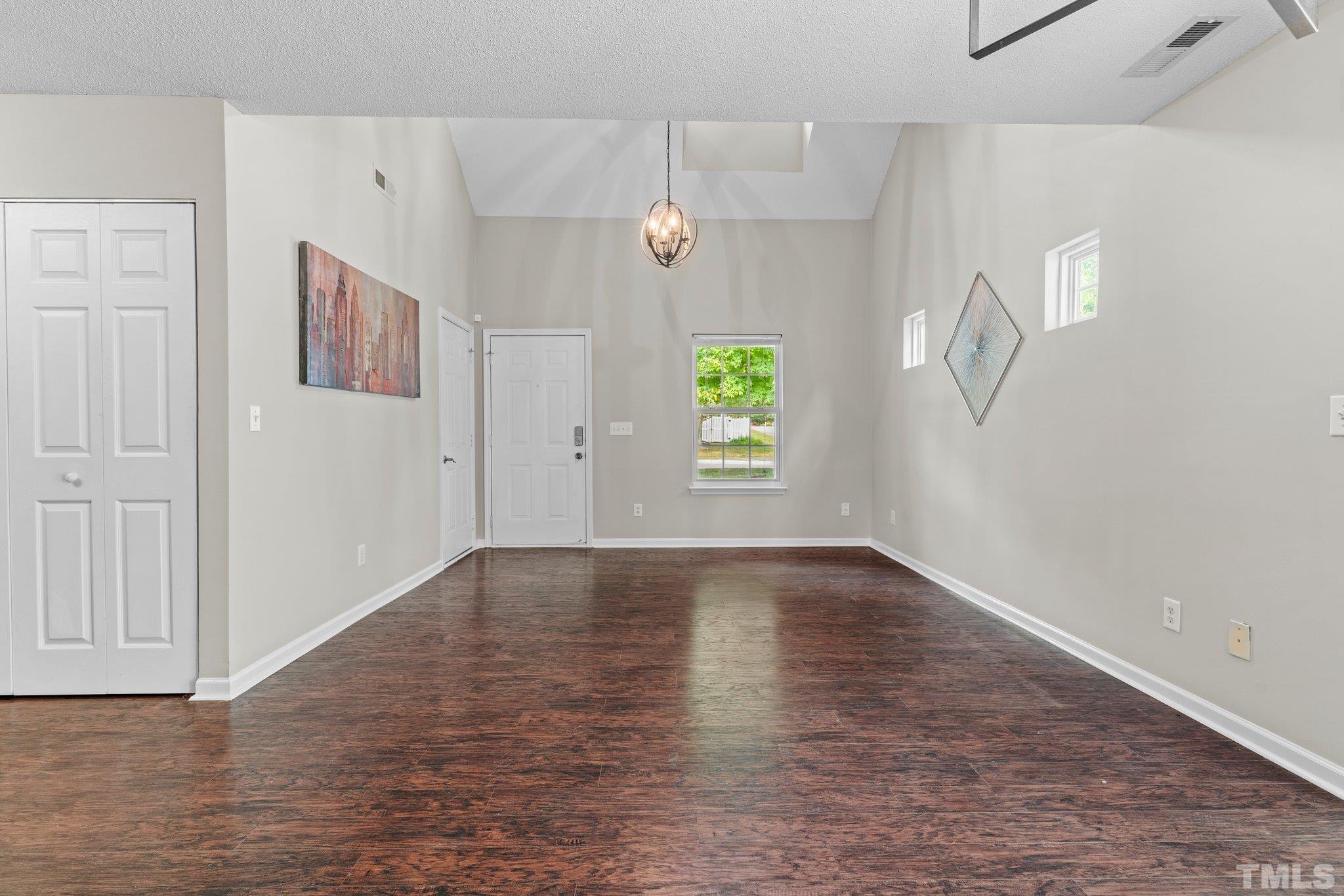 9136 Colony Village Lane Raleigh, NC 27617 - Photo 7 of 17 a view of an empty room with window and wooden floor