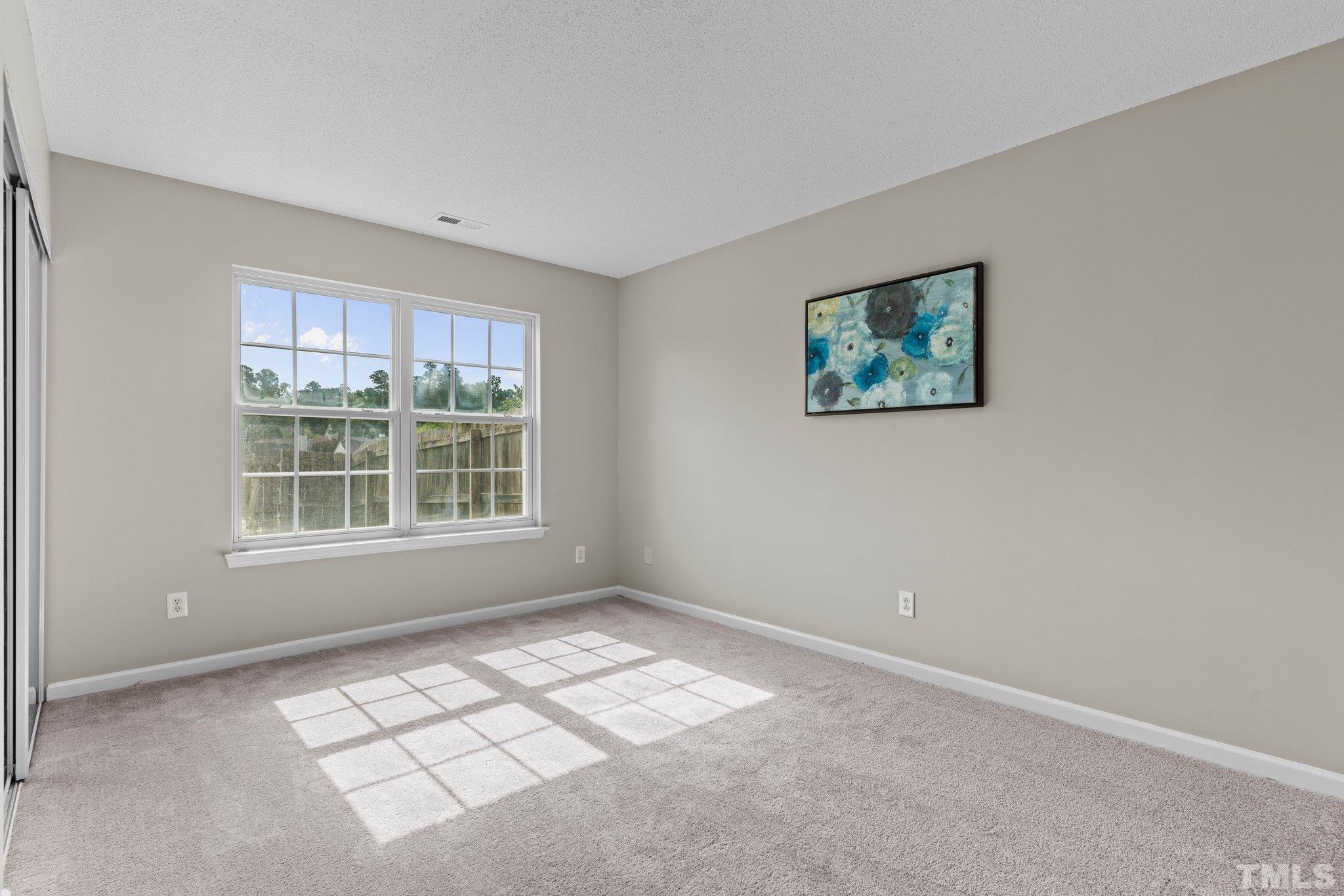 9136 Colony Village Lane Raleigh, NC 27617 - Photo 8 of 17 a view of an empty room with a window