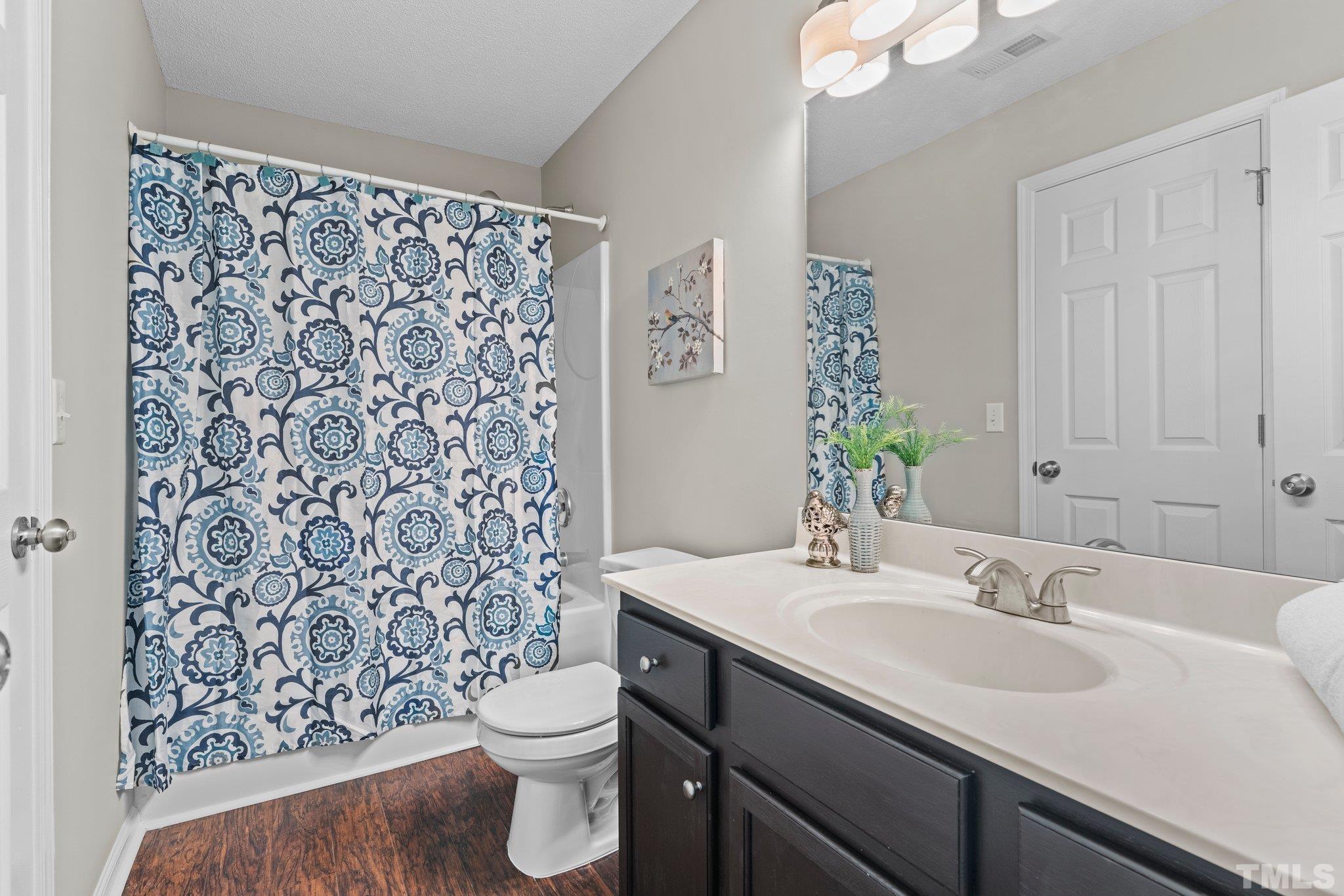 9136 Colony Village Lane Raleigh, NC 27617 - Photo 9 of 17 a bathroom with a sink toilet and shower