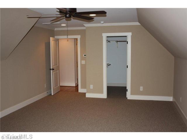 8906 West Pepper Court Oak Ridge, NC 27310 - Photo 14 of 16 Bonus. The bonus room is quite large, and has one of the many walk-in closets found in this home. All of the closets have solid shelving.
