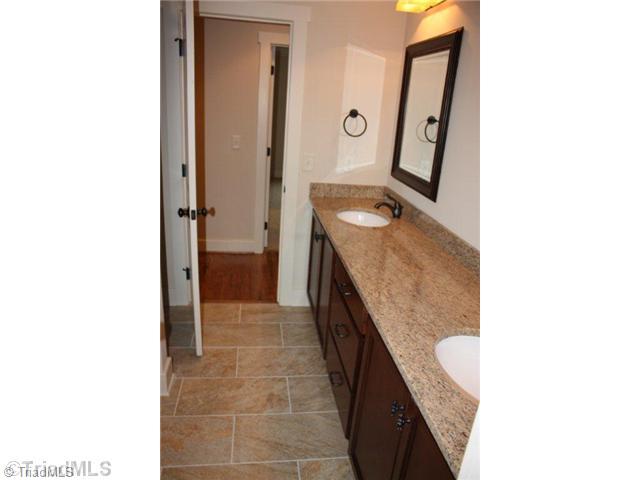 8906 West Pepper Court Oak Ridge, NC 27310 - Photo 15 of 16 Bath. The upstairs bathroom continues the custom touches.