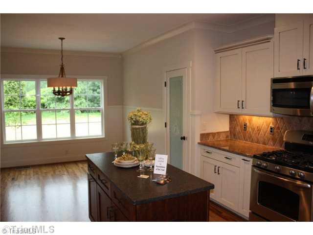 8906 West Pepper Court Oak Ridge, NC 27310 - Photo 4 of 16 Kitchen. The breakfast room is roomy and bright, and features custom wainscoting.