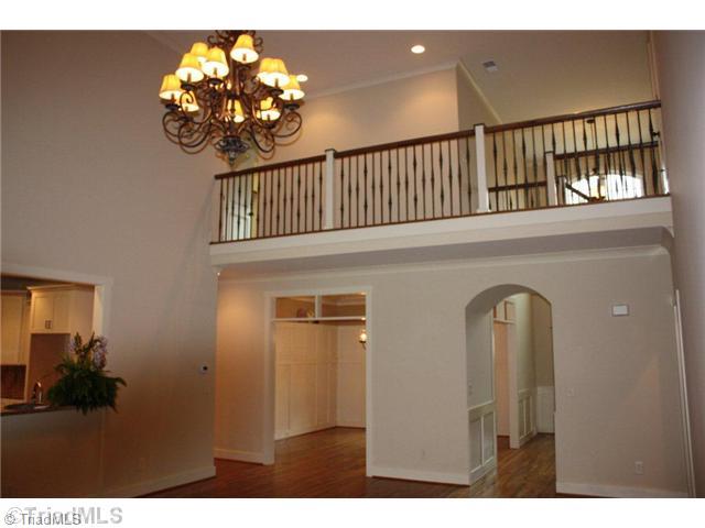 8906 West Pepper Court Oak Ridge, NC 27310 - Photo 16 of 16 Den/Family/Great Room. The Great Room is huge. It features custom lighting, a soaring ceiling, and a rock fireplace with custom rough hewn mantle. This room opens to the Kitchen/Breakfast, Dining Room, and Foyer. This is a very open floor plan.