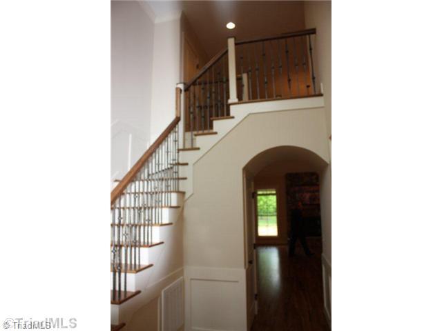 8906 West Pepper Court Oak Ridge, NC 27310 - Photo 5 of 16 Entry. The two story foyer has a winding staircase with wrought iron pickets. The barrel vault leads to the Great Room which features a beautiful stone fireplace.