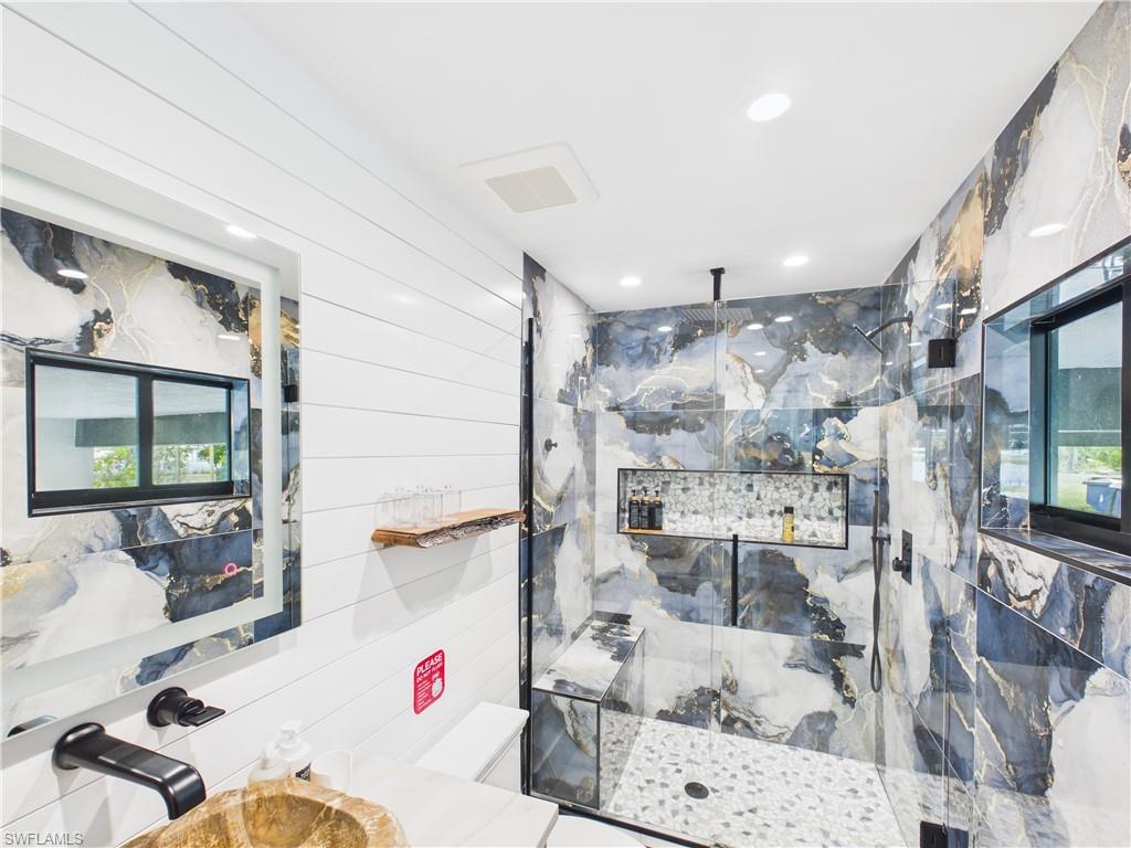 3650 Sunset Boulevard Naples, FL 34112 - Photo 25 of 37 a white bath tub sitting next to a bathroom