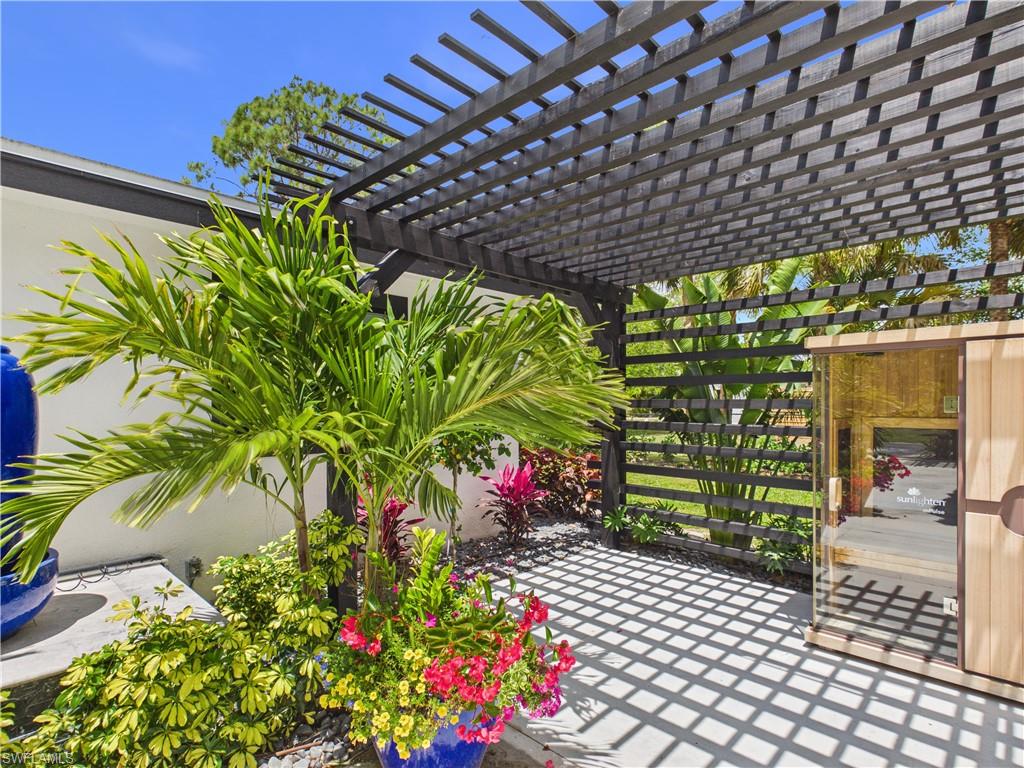 3650 Sunset Boulevard Naples, FL 34112 - Photo 33 of 37 a backyard of a house with lots of green space and a bench