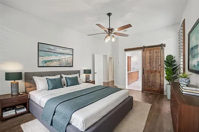 a bedroom with a large bed and a chandelier