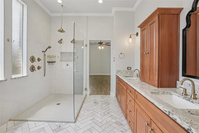 a bathroom with a granite countertop sink a mirror a shower and a bathtub