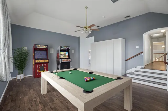 a room with pool table and windows