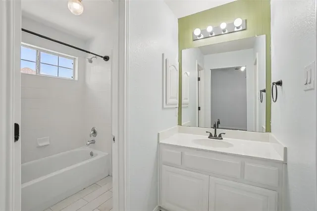 a bathroom with a bathtub a sink and a mirror