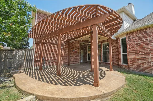 a view of a patio with a table and chairs