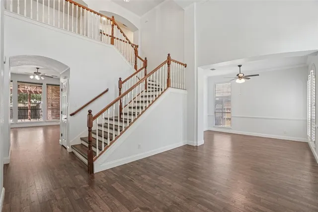 a view of staircase with wooden floor and a chandelier