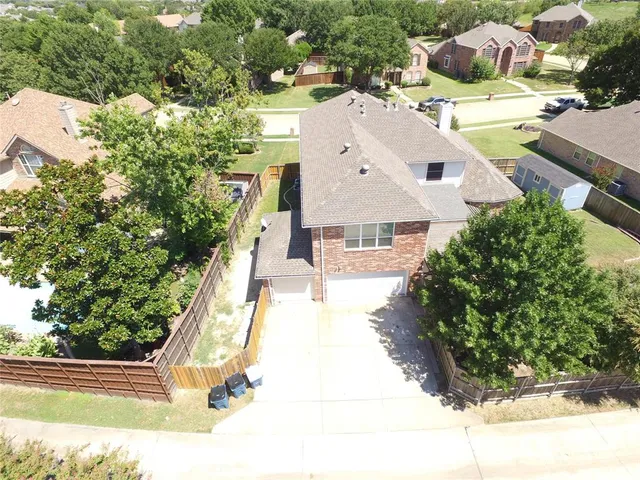 an aerial view of a house with swimming pool and ocean view