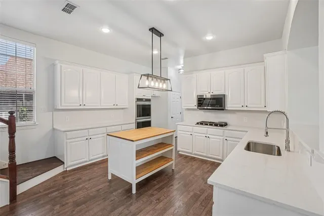a kitchen with granite countertop white cabinets and white appliances