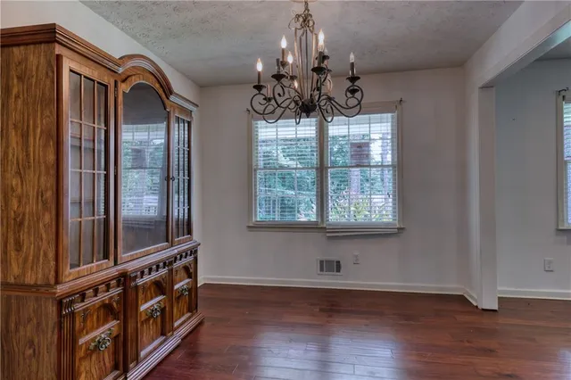 a view of a room with wooden floor