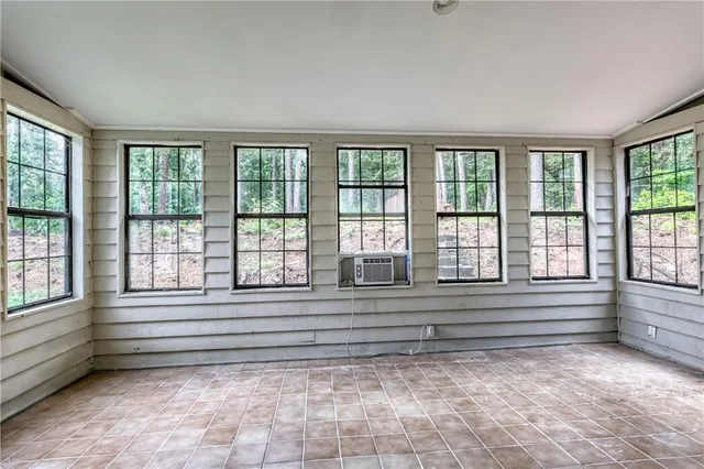 a view of empty room with window and floor to ceiling window