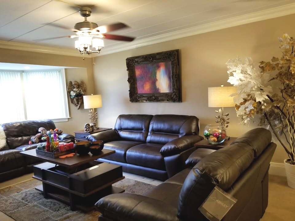 300 South Roselle Road, Unit 207 Schaumburg, IL 60193 - Photo 3 of 13 a living room with furniture a chandelier and a fireplace