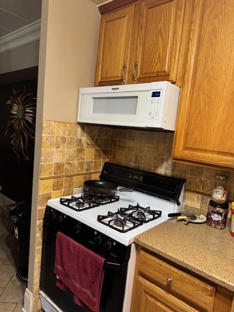 300 South Roselle Road, Unit 207 Schaumburg, IL 60193 - Photo 9 of 13 a stove top oven sitting inside of a kitchen