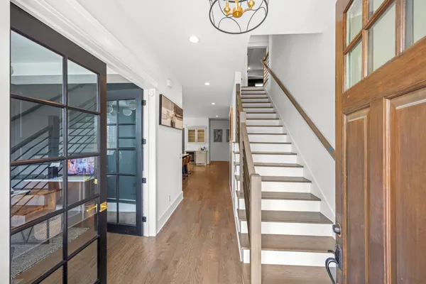 a view of entryway and hall with wooden floor