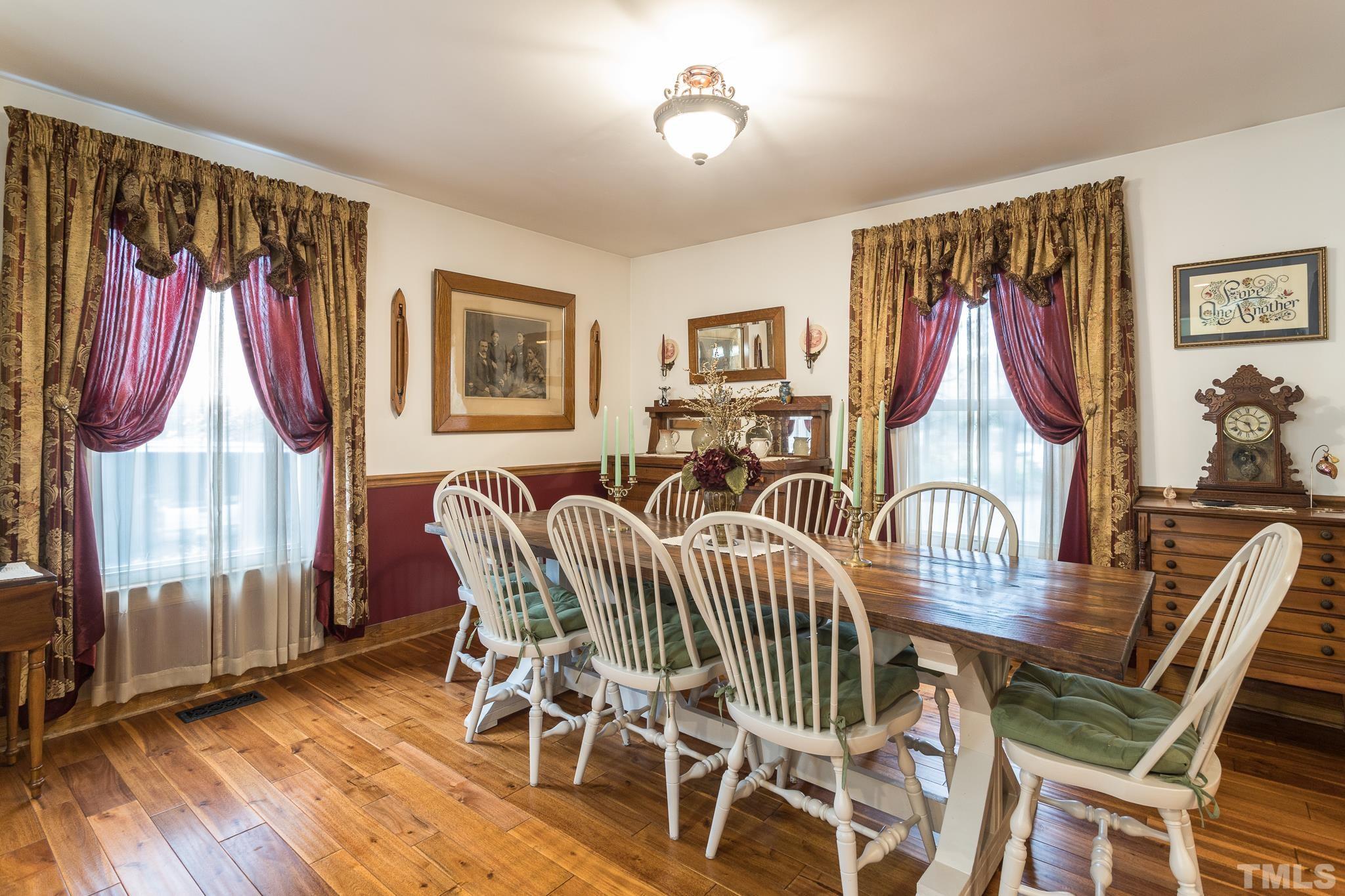 3021 Peebles Road Raleigh, NC 27616 - Photo 13 of 45 a dining room with furniture a chandelier and wooden floor