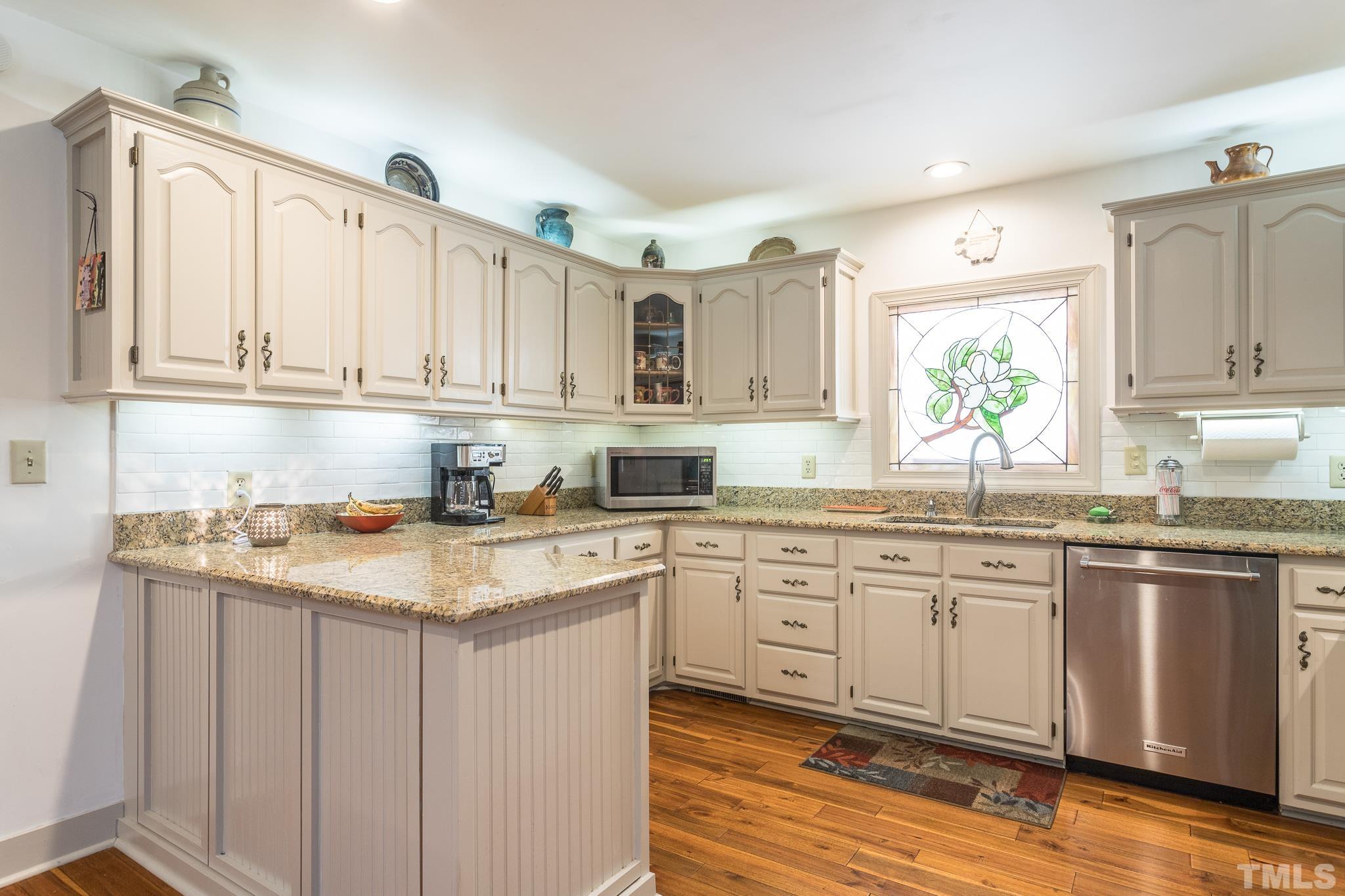 3021 Peebles Road Raleigh, NC 27616 - Photo 15 of 45 a kitchen with stainless steel appliances granite countertop a sink stove and cabinets