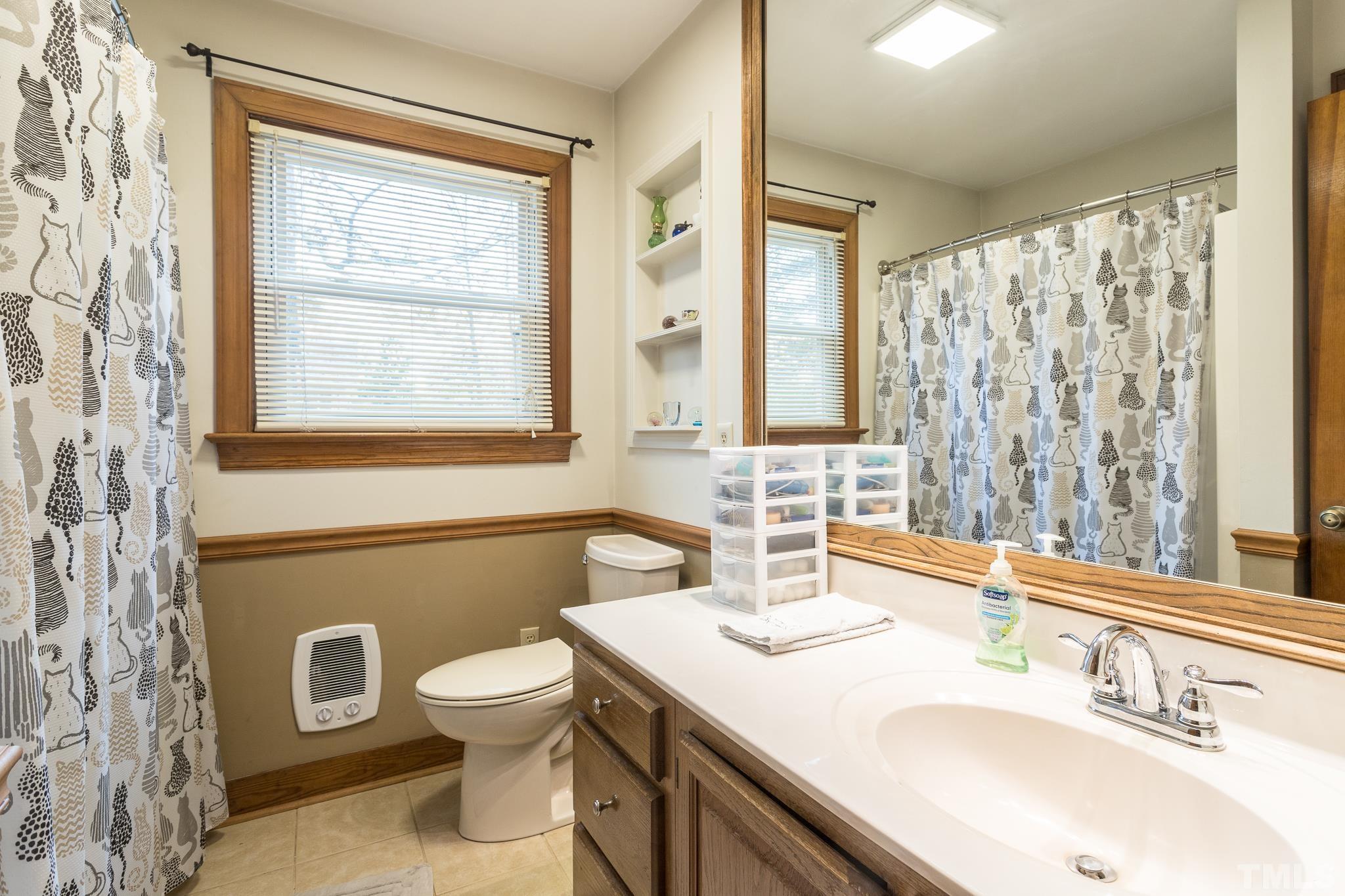 3021 Peebles Road Raleigh, NC 27616 - Photo 21 of 45 a bathroom with a toilet sink and mirror